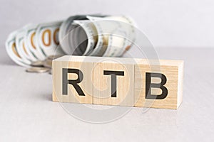 word RTB on wooden cubes, grey background