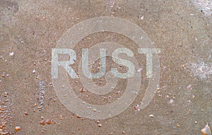 Word RUST rusting pattern rust stainless decay, resistant weather corrosive getting old passage of time time lapse Droplets of