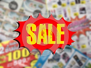 Word SALE on red speech bubble over blurred catalogue background