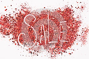 Word `sale` written on a glitter background.