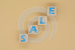 The word SALE written on wooden cubes. The concept of sales