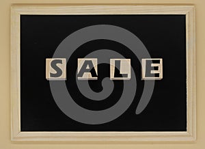 The word SALE written on wooden cubes. The concept of sales