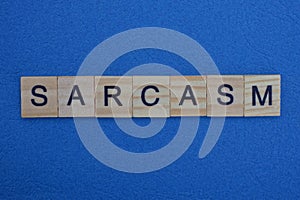 Word sarcasm made from gray wooden letters photo