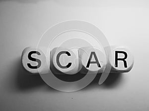 Word scar spelled on dice