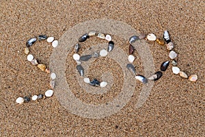 Word sea made of shells and pebbles on the sand