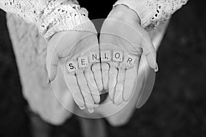 The word Senior in the hands of young lady