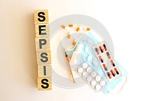 The word SEPSIS is made of wooden cubes on a white background. Medical concept