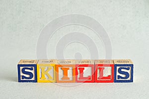 The word skills spelled with colorful blocks