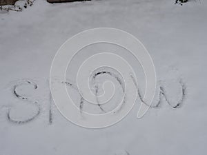 The word `snow` written in the snow