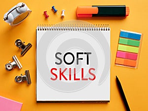 The word soft skills written on a notebook on business desktop table. People, communication, interaction, listening skills