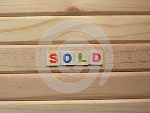 Word Sold on wood