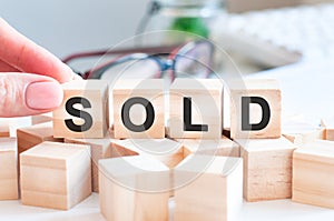 Word Sold on the wooden blocks on table, business concept