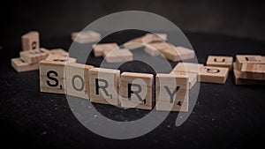 The word Sorry written on wooden letter cubes