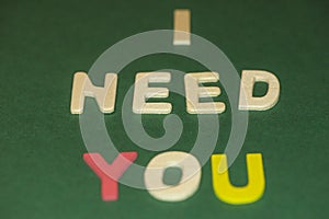 The word spelling to `I need you` on green background