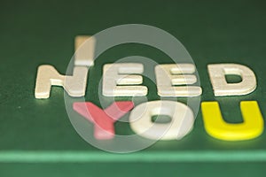 The word spelling to `I need you` on green background