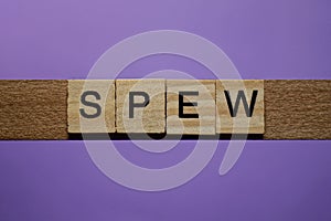 Word spew in small square wooden letters photo