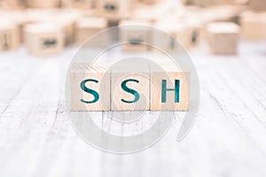 The Word SSH Formed By Wooden Blocks On A White Table