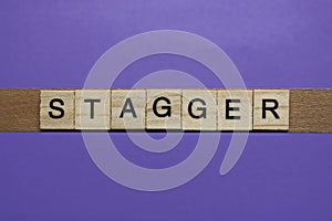 word stagger in small square wooden letters
