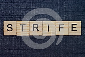 word strife from gray wooden letters photo