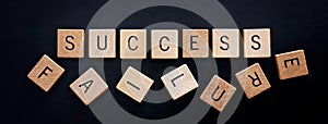 The Word Success is Spelled out in Wooden Blocks and is Knocking Down the Text Failure