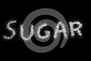 Sugar spelled out on black photo