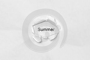 Word Summer on white isolated background through the wound hole in the paper