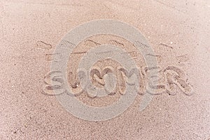 Word summer written on the beach