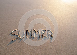 Word summer written in the sand