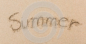 Word Summer Written in the Sand on a Beach the sea