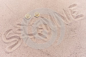 Word sun in german written on the sand of the beach