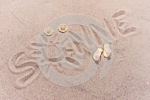 Word sun in german written on the sand of the beach