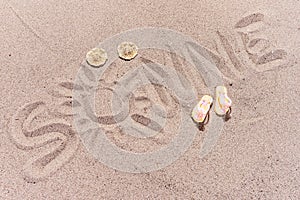 Word sun in german written on the sand of the beach
