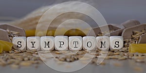 Word SYMPTOMS composed of wooden dices