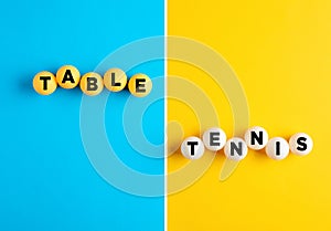 The word table tennis written on table tennis balls on blue and yellow colorful background