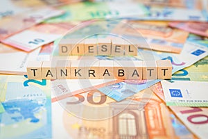 The word Tankrabatt - in German for Fuel discount - and Benzin - in German for Gasoline - in the background on banknotes Euro note