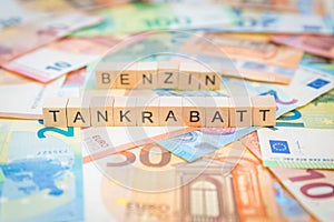 The word Tankrabatt - in German for Fuel discount - and Benzin - in German for Gasoline - in the background on banknotes Euro note photo