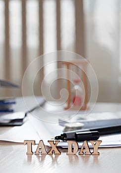 Word TAX DAY composed of wooden letters. Closeup