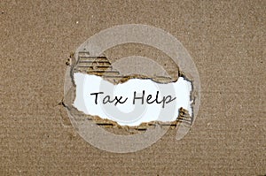 The word tax help appearing behind torn paper.