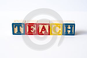 The word Teach spelled with toy blocks