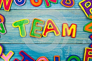 Word TEAM made with plasticine letters on old