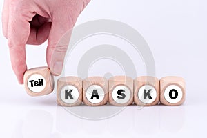 Word 'teilkasko' on wooden blocks