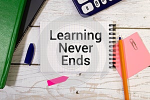 Word text Learning never end on white paper on office table / business concept