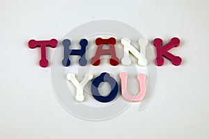 The word Thank You formed with colorful felt letters