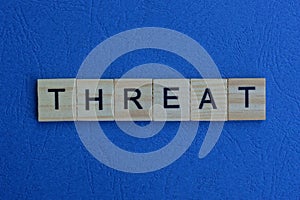 The word threat from brown wooden letters