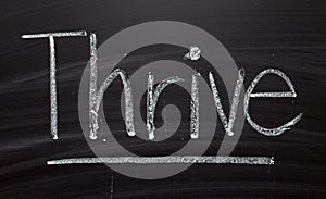 The word Thrive on a Blackboard photo