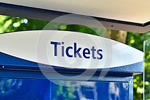 Word `Ticket` at blue public transportation ticket machine