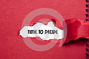 The word time to decide appearing behind torn paper