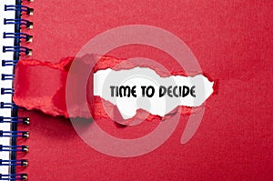 The word time to decide appearing behind torn paper