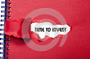 The word time to invent appearing behind torn paper