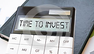 Word time to invest on calculator. Business and finance concept